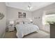 This bedroom is a calm, neutral palette with white wicker furniture, a window and nice decor at 1662 Bobcat Trl, North Port, FL 34288