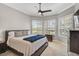A bright bedroom featuring a king-sized bed and bay windows with plantation shutters at 1662 Bobcat Trl, North Port, FL 34288
