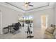 Bonus room with comfortable seating and exercise equipment overlooking the pool at 1662 Bobcat Trl, North Port, FL 34288
