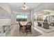 Bright dining area with a view of the screened-in pool area and backyard landscaping at 1662 Bobcat Trl, North Port, FL 34288
