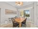 Cozy dining area with a wooden table, four chairs, and a view of the screened patio and pool at 1662 Bobcat Trl, North Port, FL 34288