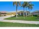 Beautiful home with a well-manicured lawn, lush landscaping, and a three-car garage at 1662 Bobcat Trl, North Port, FL 34288