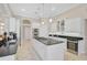 Elegant kitchen with stainless steel appliances, granite counters, island, and abundant white cabinetry at 1662 Bobcat Trl, North Port, FL 34288