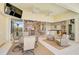 Relaxing lanai with views of the living room, kitchen, pool, outdoor seating and dining area at 1662 Bobcat Trl, North Port, FL 34288