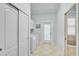 Light and airy laundry room with tile floors, washer, dryer, and access to the outdoors at 1662 Bobcat Trl, North Port, FL 34288