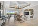 Bright living room featuring tile floors, coffered ceiling, built-in shelving, and sliders to the outdoor pool area at 1662 Bobcat Trl, North Port, FL 34288