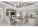 Inviting living room with tile flooring, coffered ceiling, built-in shelving, and views to the dining area at 1662 Bobcat Trl, North Port, FL 34288