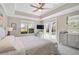 Bright main bedroom features a tray ceiling, ceiling fan, and lanai access at 1662 Bobcat Trl, North Port, FL 34288