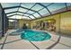 A serene screened-in pool area with a spa provides a refreshing retreat with outdoor living space at 1662 Bobcat Trl, North Port, FL 34288