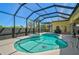 An inviting screened-in pool and spa area, surrounded by greenery and offering a relaxing outdoor oasis at 1662 Bobcat Trl, North Port, FL 34288