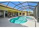 Beautiful screened-in pool with an attached spa, outdoor kitchen, covered lanai and access to multiple rooms at 1662 Bobcat Trl, North Port, FL 34288
