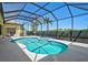 Lovely screened-in pool and spa featuring a covered lanai, complemented by lush landscaping and palm trees at 1662 Bobcat Trl, North Port, FL 34288