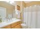 Bright bathroom featuring a vanity with modern fixtures and a shower with a white curtain at 1683 San Silvestro Dr, Venice, FL 34285