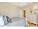 Bright bedroom with hardwood floors, natural light, and a view to the kitchen at 1683 San Silvestro Dr, Venice, FL 34285
