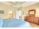 Spacious bedroom featuring hardwood floors, with a view to the bathroom and living room at 1683 San Silvestro Dr, Venice, FL 34285