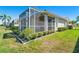 Exterior view of the property showcasing a screened lanai and well-maintained landscaping at 1683 San Silvestro Dr, Venice, FL 34285