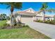 Attractive home showcasing lush landscaping, a tile roof, and a spacious driveway at 1683 San Silvestro Dr, Venice, FL 34285