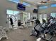Bright fitness center featuring modern exercise equipment, large windows, and multiple televisions for entertainment at 1683 San Silvestro Dr, Venice, FL 34285