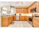 Well-equipped kitchen with stainless steel appliances, granite countertops, and wood cabinets at 1683 San Silvestro Dr, Venice, FL 34285