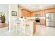 Eat-in kitchen bar with seating, granite countertops, and stainless steel appliances at 1683 San Silvestro Dr, Venice, FL 34285