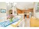 Bright kitchen with tile floors, wood cabinets, and stainless steel appliances, eat-in kitchen area at 1683 San Silvestro Dr, Venice, FL 34285