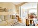 Inviting living area with archway, column, neutral colors, wood floors, and adjacent dining space at 1683 San Silvestro Dr, Venice, FL 34285