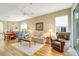 Cozy living room with hardwood floors, comfortable seating, and natural light at 1683 San Silvestro Dr, Venice, FL 34285