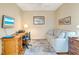 Bright office space featuring a comfortable couch, desk, and ceiling fan, perfect for working from home at 1683 San Silvestro Dr, Venice, FL 34285