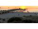 Sunset at the pier with people enjoying the beach and the beautiful twilight sky, perfect for evening strolls at 1683 San Silvestro Dr, Venice, FL 34285