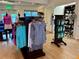 Well-lit golf pro shop featuring clothing, golf shoes, and accessories neatly displayed on racks and shelves at 1683 San Silvestro Dr, Venice, FL 34285