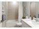 Bathroom boasting tile, a shower with a curtain, and quartz countertop vanity at 16848 Cayo Key Dr, Port Charlotte, FL 33953