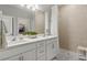 Bright bathroom featuring double sinks, a walk-in shower, and modern fixtures at 16848 Cayo Key Dr, Port Charlotte, FL 33953