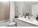 Modern bathroom with a shower featuring tile surround and a white quartz countertop vanity at 16848 Cayo Key Dr, Port Charlotte, FL 33953