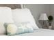 Comfortable bedroom features a decorative throw pillow, side lamp, and a neutral color scheme at 16848 Cayo Key Dr, Port Charlotte, FL 33953