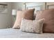Close-up of the bed featuring decorative pillows with intricate designs and soft neutral tones at 16848 Cayo Key Dr, Port Charlotte, FL 33953