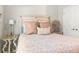 Cozy bedroom featuring neutral tones and decorative pillows and a large headboard at 16848 Cayo Key Dr, Port Charlotte, FL 33953