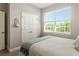 Bedroom featuring a window letting in natural light, double doors, and a soft color palette at 16848 Cayo Key Dr, Port Charlotte, FL 33953