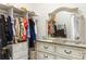 Spacious closet with ample storage, drawers, hanging space, and a decorative mirror at 16848 Cayo Key Dr, Port Charlotte, FL 33953