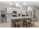 Modern kitchen with white cabinets, stainless steel appliances, and a center island with seating at 16848 Cayo Key Dr, Port Charlotte, FL 33953