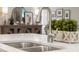 Close up on the kitchen sink with stainless faucet and view of decorative items in the background at 16848 Cayo Key Dr, Port Charlotte, FL 33953