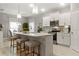 Modern kitchen with island, stylish stools, pendant lights, and stainless appliances at 16848 Cayo Key Dr, Port Charlotte, FL 33953
