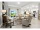 Open concept living room and kitchen with light tile flooring and plenty of natural light at 16848 Cayo Key Dr, Port Charlotte, FL 33953