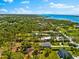Expansive aerial view of a charming neighborhood with lush greenery and waterway views at 1785 Bayshore Dr, Englewood, FL 34223