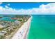 Gorgeous aerial view of the sandy beach with emerald water, buildings and plenty of parking at 1785 Bayshore Dr, Englewood, FL 34223