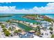 Aerial view of the harbor showing waterways, beaches, and marina with boats on a sunny day at 1785 Bayshore Dr, Englewood, FL 34223