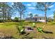 Backyard featuring a fire pit area with seating, with the home and pool visible in the background at 1785 Bayshore Dr, Englewood, FL 34223