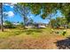 Backyard featuring a fire pit area with seating, with the home and pool visible in the background at 1785 Bayshore Dr, Englewood, FL 34223