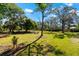 Large grassy backyard featuring a fire pit and seating area at 1785 Bayshore Dr, Englewood, FL 34223
