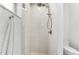 Shower featuring a rainfall shower head, tiled walls and pebble flooring at 1785 Bayshore Dr, Englewood, FL 34223