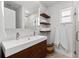 Modern bathroom featuring double vanity, floating shelves and clean lines at 1785 Bayshore Dr, Englewood, FL 34223